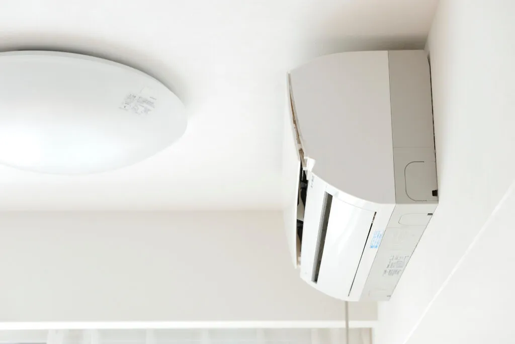 Wall-mounted air conditioning unit and ceiling light. Debunking common Air Conditioning Myths for efficient cooling solutions | Accurate Air