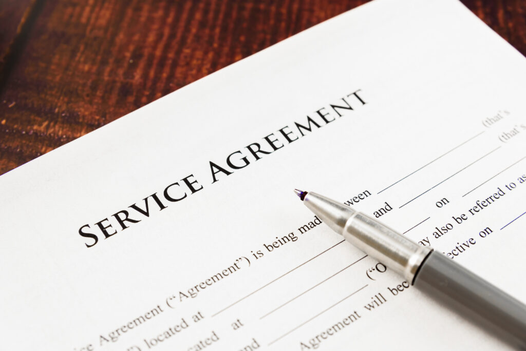 Reasons for a Planned Service Agreement: Pen on a service contract. Consider a PSA for HVAC maintenance and peace of mind | Accurate Air