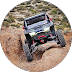 Home image of an off-road vehicle navigating a rocky desert landscape, showcasing its rugged capabilities and design | Accurate Air