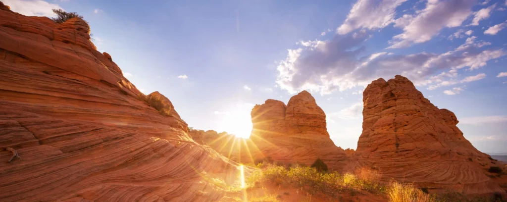 Red sandstone formations under a blazing summer sun.